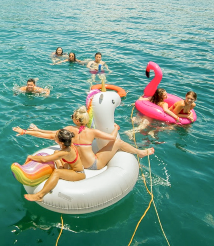 People relaxing on pool floats in summer. Poolfloathk